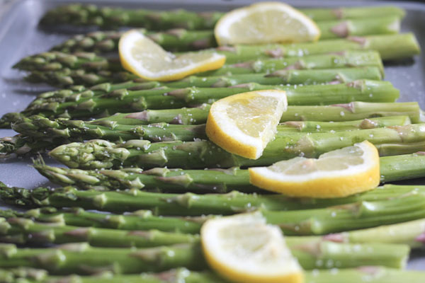 fresh asparagus on a baking sheet