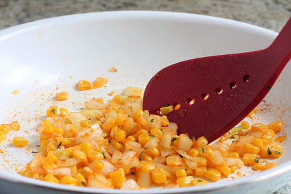 cooking corn with the rice in the skillet