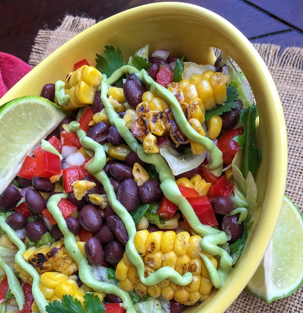 fresh corn salad drizzled with avocado dressing