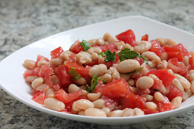 tusan beans and diced tomatoes in a bowl