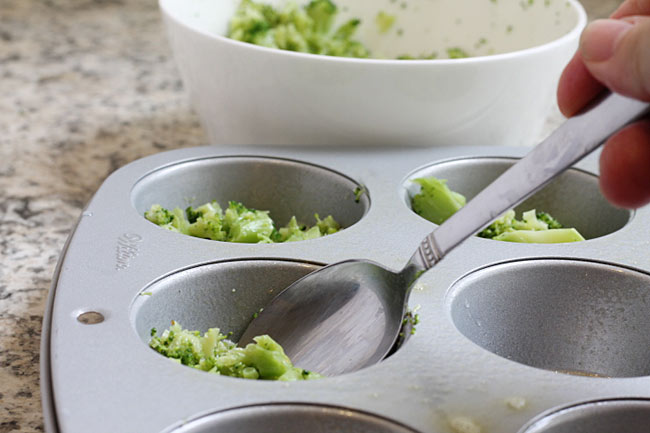 spoon buttered broccoli into muffin cups