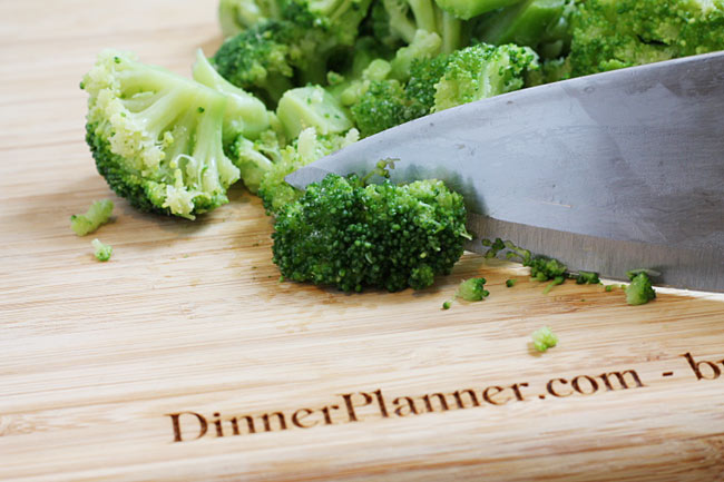 chopped broccoli on a cutting board