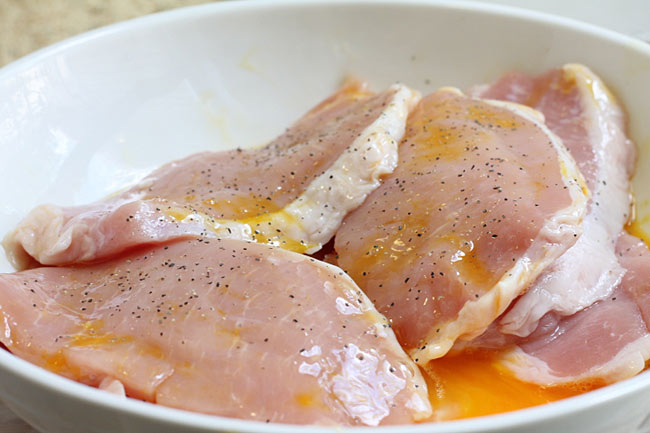 coat pork chops in egg mixture