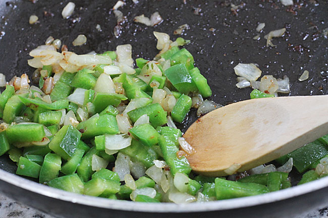 cooking green pepper and onions